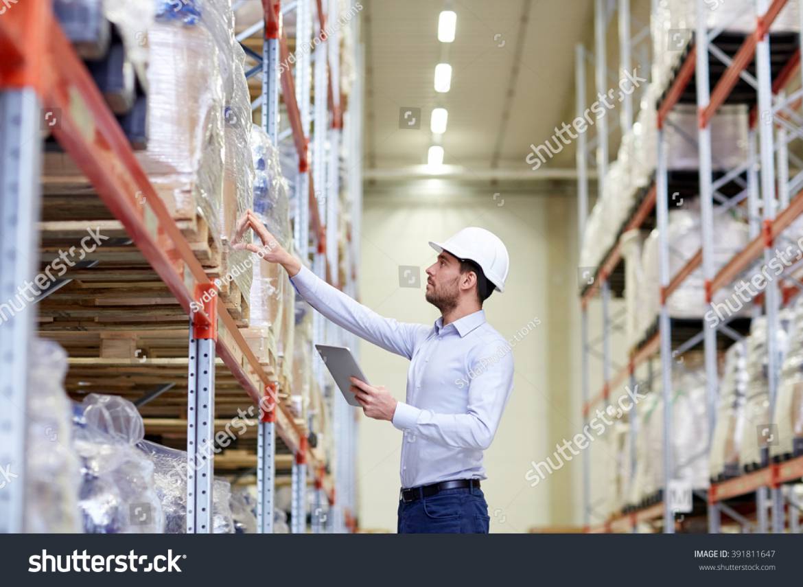 stock-photo-wholesale-logistic-business-export-and-people-concept-man-or-manager-in-hardhat-with-tablet-pc-391811647.jpg